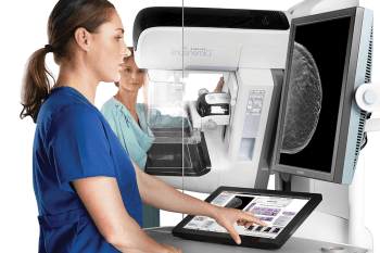 nurse viewing a 3d mammography machine